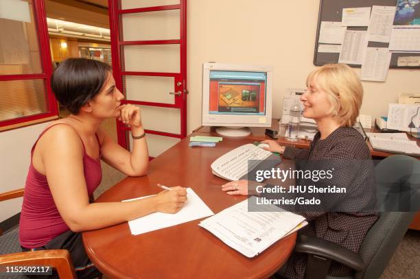 Librarian Helping Patron Photos and Premium High Res Pictures - Getty ...