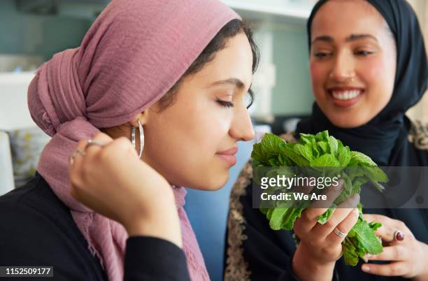 young women preparing ramadan iftar meal - smelling food imagens e fotografias de stock