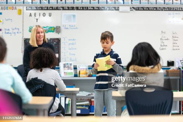 young caucasian boy presenting to his class - kid presenting stock pictures, royalty-free photos & images