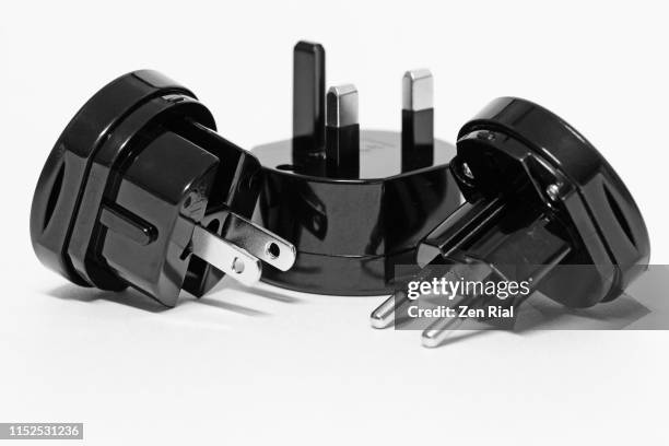 universal travel adapter on white background - adaptador fotografías e imágenes de stock