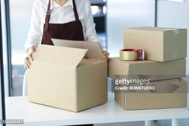 worker preparing packages for delivery - send parcel stock pictures, royalty-free photos & images