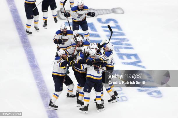 Carl Gunnarsson of the St. Louis Blues is congratulated by his teammates after scoring the game winning goal during the first overtime period against...
