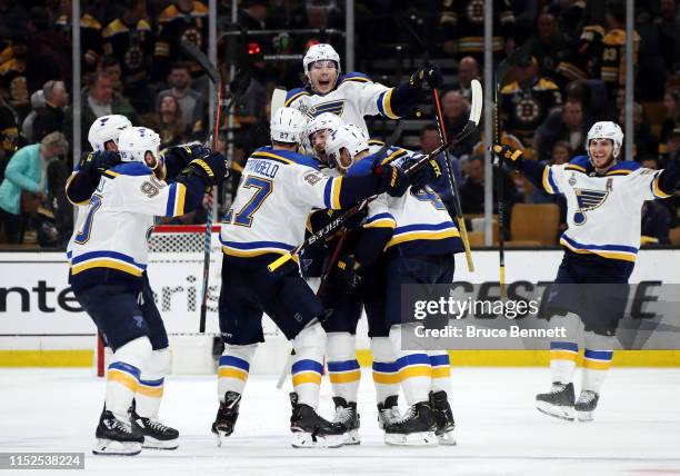 Carl Gunnarsson of the St. Louis Blues is congratulated by his teammates after scoring the game winning goal during the first overtime period against...