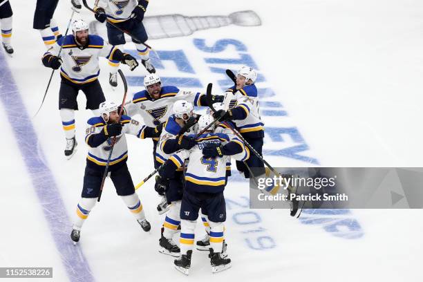 Carl Gunnarsson of the St. Louis Blues is congratulated by his teammates after scoring the game winning goal during the first overtime period against...