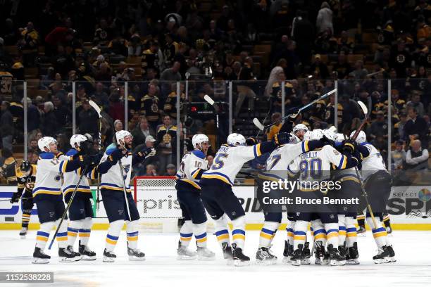Carl Gunnarsson of the St. Louis Blues is congratulated by his teammates after scoring the game winning goal during the first overtime period against...