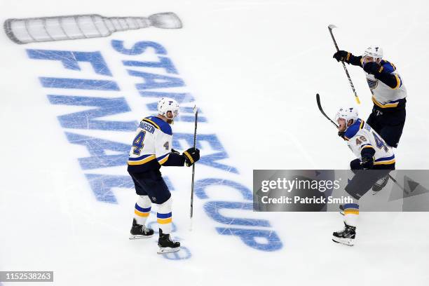 Carl Gunnarsson of the St. Louis Blues is congratulated by his teammates Ivan Barbashev and Alex Pietrangelo after scoring the game winning goal...