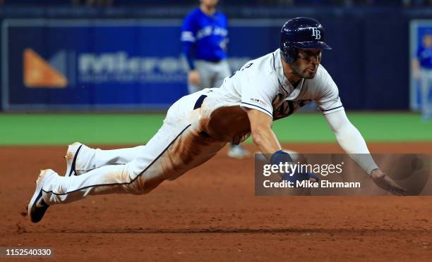 Kevin Kiermaier of the Tampa Bay Rays slides into third in the 10th inning during a game against the Toronto Blue Jays at Tropicana Field on May 29,...