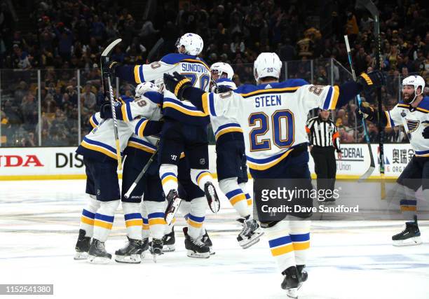 Carl Gunnarsson of the St. Louis Blues celebrates with teammates after scoring the game-winning goal during the first overtime period to defeat the...