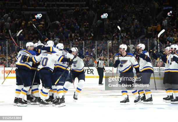 Carl Gunnarsson of the St. Louis Blues celebrates with teammates after scoring the game-winning goal during the first overtime period to defeat the...