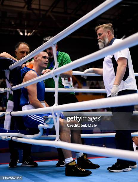 Minsk , Belarus - 28 June 2019; Michael Nevin of Ireland is tended to by coaches Zaur Antia and John Conlon, and the ringside doctor following a...