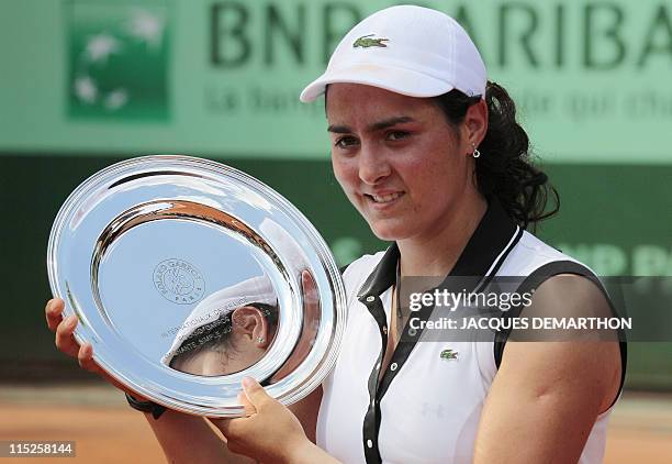 Tunisia's Ons Jabeur holds the trophy after winning over Peurto Rico's Monica Puig during their Girls's Singles final match in the French Open tennis...