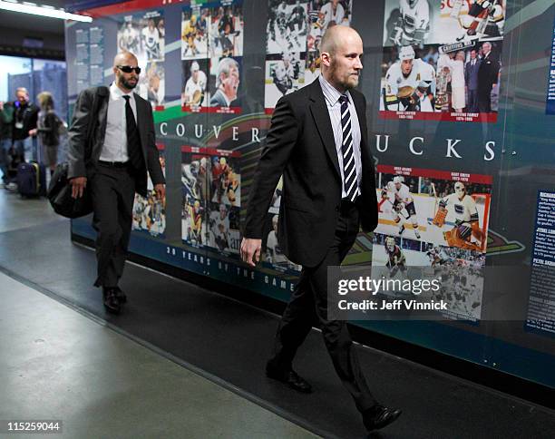 Manny Malhotra and Sami Salo of the Vancouver Canucks walk to their dressing room before Game One of 2011 NHL Stanley Cup Finals against the Boston...
