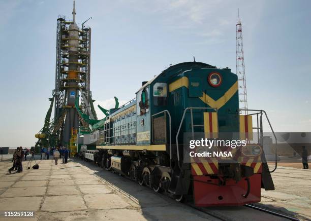 In this handout photo provided by NASA, the Soyuz TMA-02M spacecraft is rolled out by train to the launch pad at the Baikonur Cosmodrome in Baikonur,...