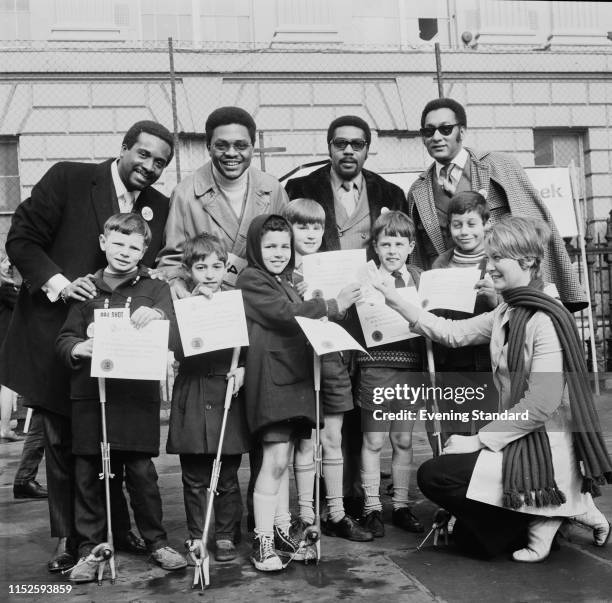 American soul vocal group Four Tops with schoolchildren from Hiterfield School, London, UK, 16th March 1970.