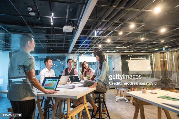 coworkers on business meeting in modern space - asia stock pictures, royalty-free photos & images