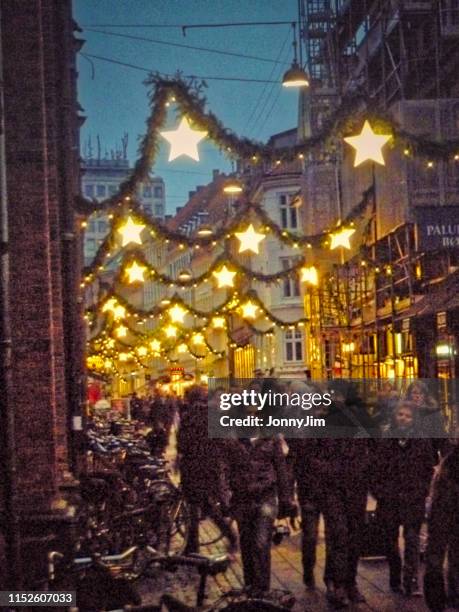 christmas lights decorating pedestrianized main street copenhagen denmark - copenhagen christmas stock pictures, royalty-free photos & images