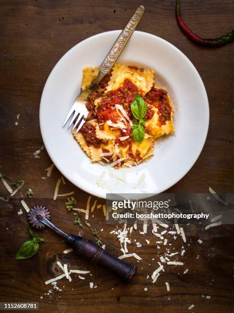 ravioli pasta with bolognese sauce, basil and cheese - tomato sauce stock pictures, royalty-free photos & images