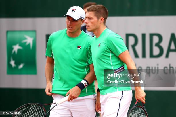 Ken Skupski and Neal Skupski of Great Britain in their doubles match against Bob Bryan and Mike Bryan of The United States during Day five of the...