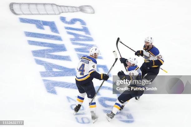 Carl Gunnarsson of the St. Louis Blues is congratulated by his teammates Ivan Barbashev and Alex Pietrangelo after scoring the game-winning goal...