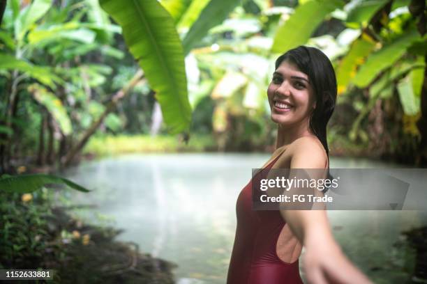 girlfriend holding boyfriend hands exploring and discovery fervedouro in tocantins, brazil - tocantins stock pictures, royalty-free photos & images