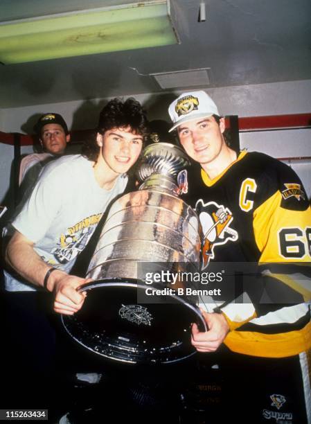 Jaromir Jagr and Mario Lemieux of the Pittsburgh Penguins pose with the Stanley Cup in the locker room after Game 4 of the 1992 Stanley Cup Finals...