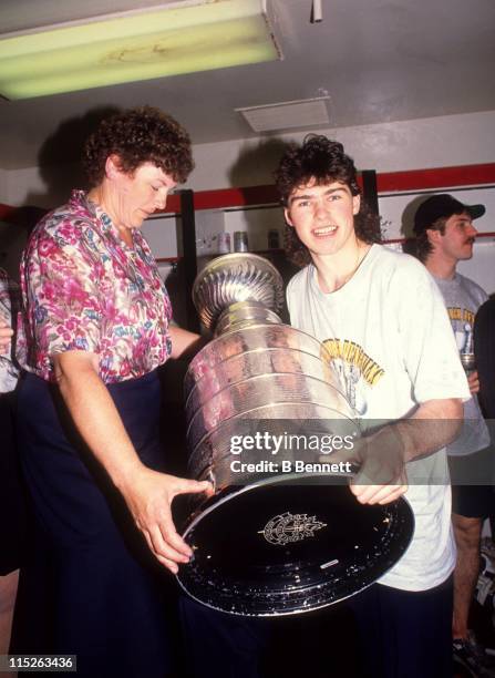 Jaromir Jagr of the Pittsburgh Penguins poses with his mom and the Stanley Cup in the locker room after Game 4 of the 1992 Stanley Cup Finals against...