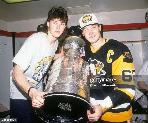 Jaromir Jagr and Mario Lemieux of the Pittsburgh Penguins pose with the Stanley Cup in the locker room after Game 4 of the 1992 Stanley Cup Finals...