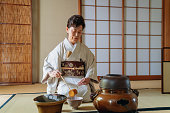 Japanese tea master making a cup of traditional matcha tea