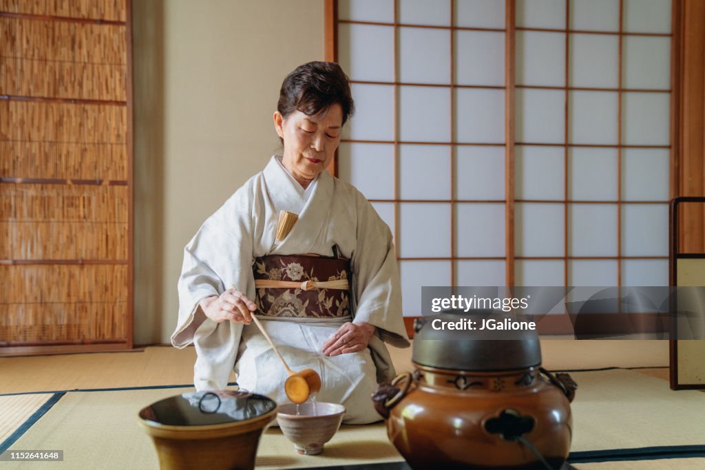 Japanese tea master making a cup of traditional matcha tea