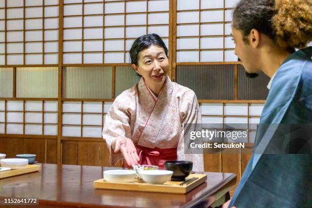 traveler eating breakfast at ryokan, japanese inn - washitsu stock pictures, royalty-free photos & images