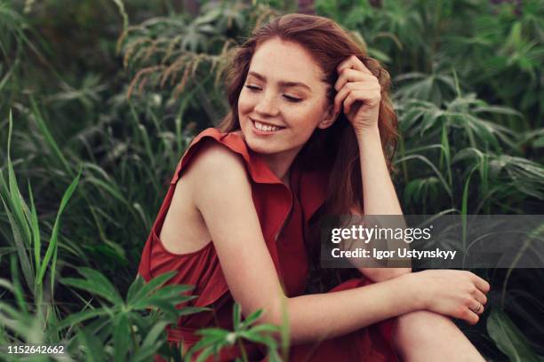portrait of laughing young woman with freckles outdoors - hand in hair stock pictures, royalty-free photos & images