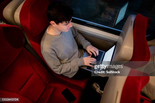 working on the go - working on laptop in train top view stock pictures, royalty-free photos & images