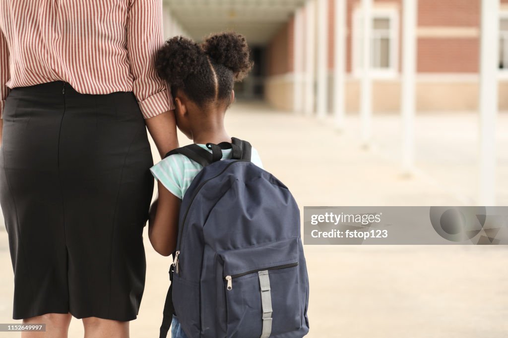 Elementary, African American girl with mom on first day of school.