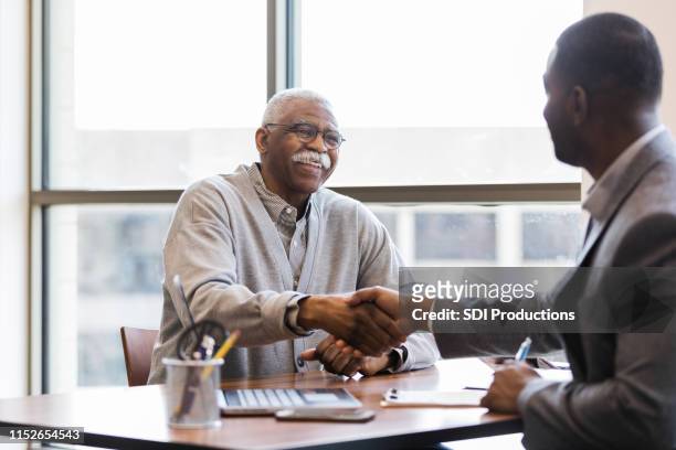 mature man is hired to handle outreach to senior adults - old accountant stock pictures, royalty-free photos & images