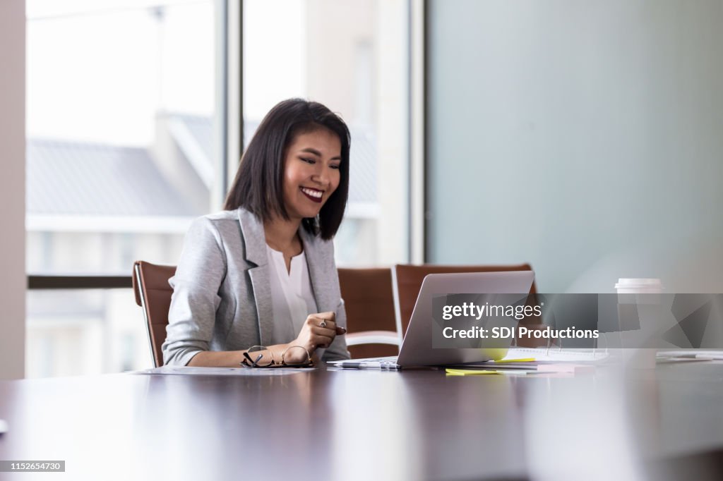 Cheerful young businesswoman video chats with colleague