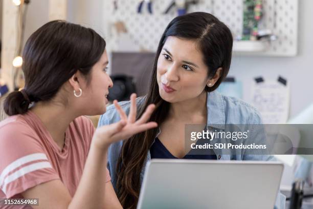 native american mother listens to daughter's explanation - indian aunt stock pictures, royalty-free photos & images