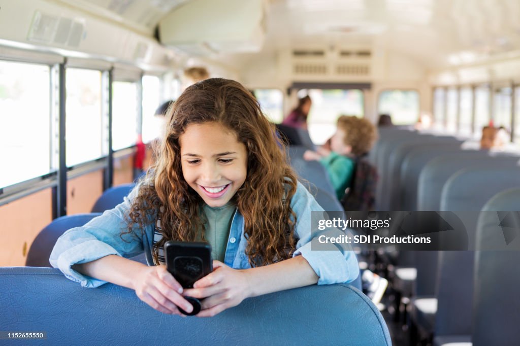 Girl Getting A Message Girl Smiles At The Text Message Sent By Her Sister High-Res Stock Photo ...