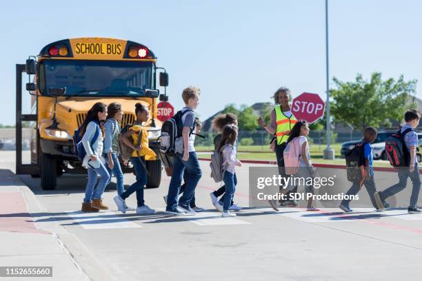 school children cross the street - school bus kids stock pictures, royalty-free photos & images