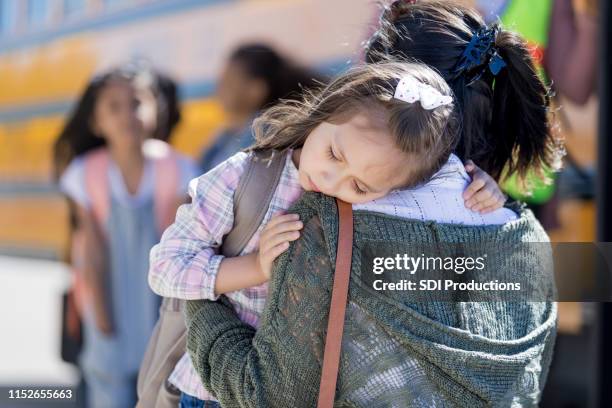 a young schoolgirl is sad to leave her mother - working class mother stock pictures, royalty-free photos & images