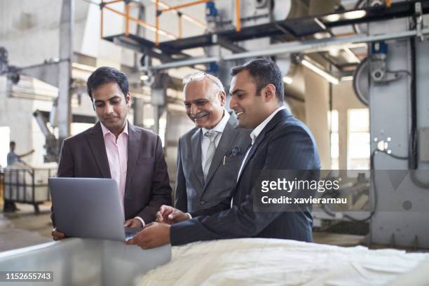 glimlachende indiase leidinggevenden ontmoeten elkaar op de fabriek vloer - factory owner stockfoto's en -beelden