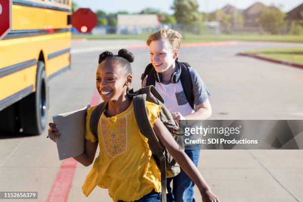 two best friends race to the school bus - last day of school stock pictures, royalty-free photos & images