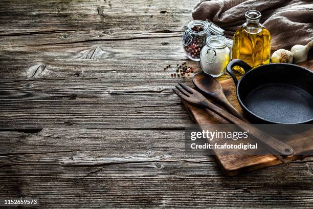 cooking backgrounds: cooking ingredients and utensils on rustic wooden table with copy space - chopping board background stock pictures, royalty-free photos & images