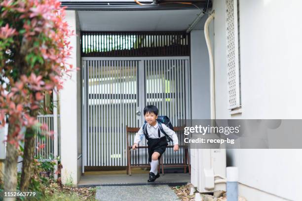 excited boy leaving home for school - school building entrance stock pictures, royalty-free photos & images