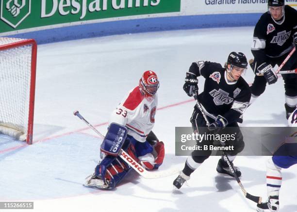 Goalie Patrick Roy of the Montreal Canadiens looks to make the save as Luc Robitaille of the Los Angeles Kings tries to set a screen during Game 1 of...