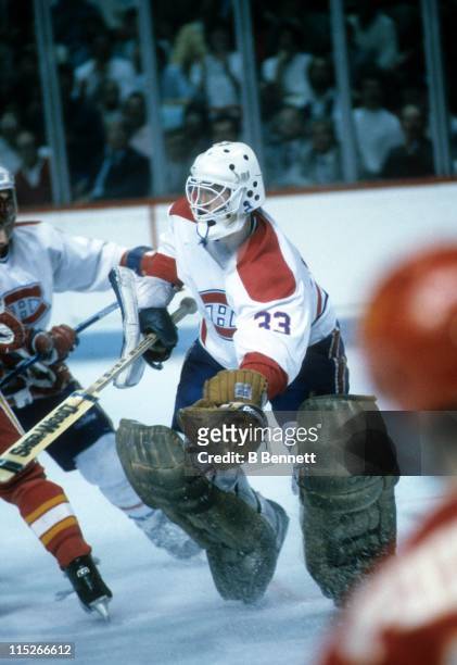 Goalie Patrick Roy of the Montreal Canadiens gloves the puck during an NHL game against the Calgary Flames circa 1986 at the Montreal Forum in...
