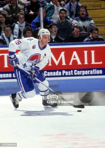 Joe Sakic of the Quebec Nordiques skates with the puck during an NHL game circa 1992 at the Quebec Coliseum in Quebec City, Quebec, Canada.