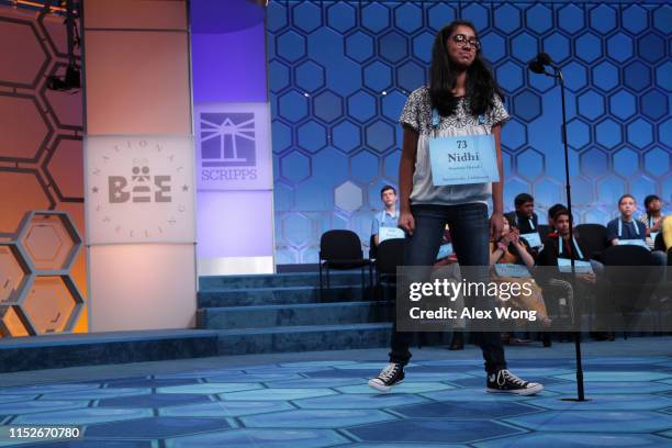 Nidhi Vadlamudi of Santa Clara, California, reacts after she misspelled the word "kulah" during round five of the Scripps National Spelling Bee at...