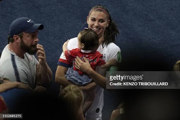 United States' forward Alex Morgan holds her baby as she celebrates at the end of the France 2019 Women's World Cup quarter-final football match...