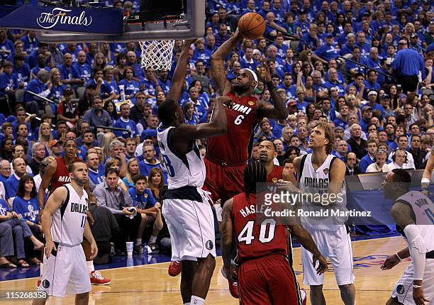 LeBron James of the Miami Heat attempts a dunk in the first half against Ian Mahinmi of the Dallas Mavericks in Game Three of the 2011 NBA Finals at...