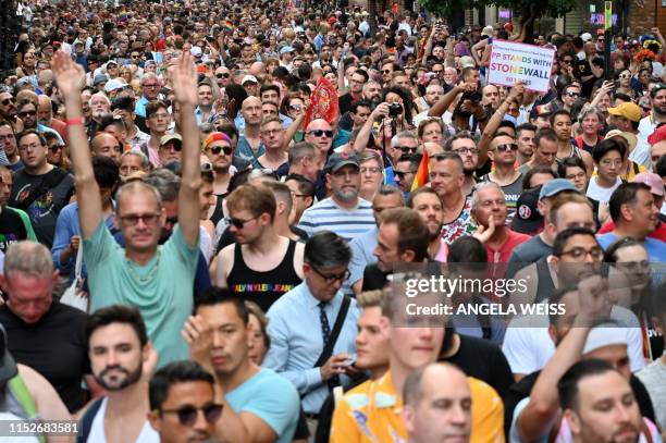 Crowds gather on Christopher Street outside the Stonewall Inn for a rally to mark the 50th anniversary of the Stonewall Riots in New York, June 28,...